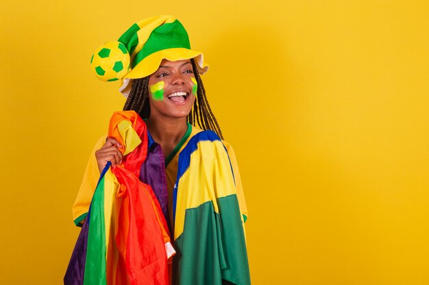 Black woman cheerleader holding brazil flag and lgbt flag lgbt\
pride diversity female empowerment