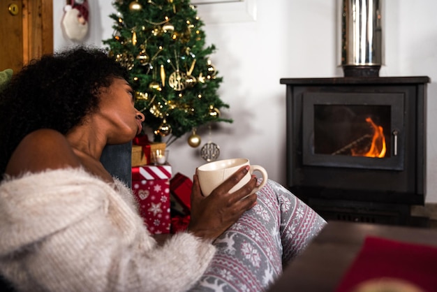 Black woman drinking hot beverage