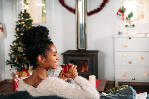 Black woman drinking hot beverage