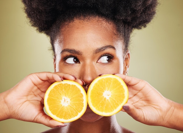 Black woman face or thinking of orange fruit skincare vitamin c dermatology or organic facial ideas on green studio background Zoom beauty model or natural hair and citrus healthy food wellness