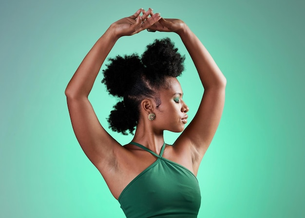 Black woman fashion and dance model pose of a person from Jamaica confident Beauty and female empowerment of a salsa dancing and posing dancer with confidence in a studio with a green background
