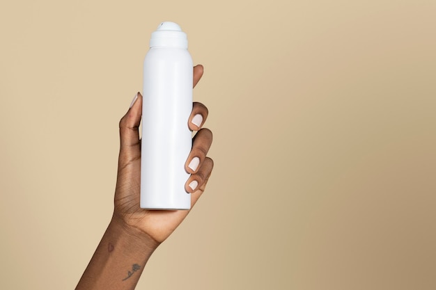 Black woman holding a white spray bottle