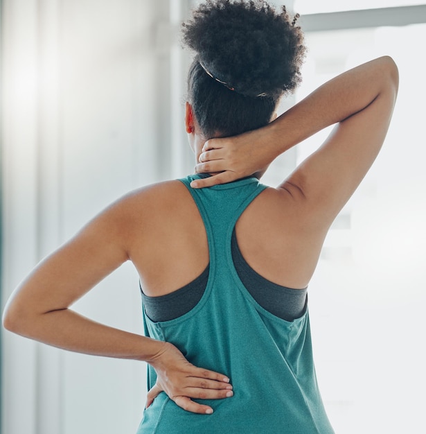 Photo black woman neck and back pain at exercise training or workout for physical development in home girl muscle stress and burnout at gym for fitness wellness and performance with injury in gym