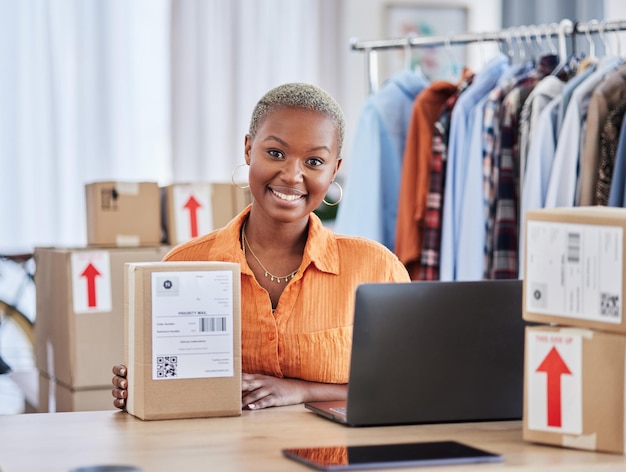 Black woman portrait and box of fashion designer in small business logistics or service at boutique Happy creative African female person smile with boxes in courier startup or retail clothing store