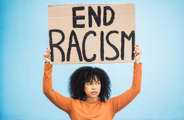 black woman protest sign and angry at racism fight for equality human rights and freedom isolated on blue background global problem social justice and revolution anger in studio and politics