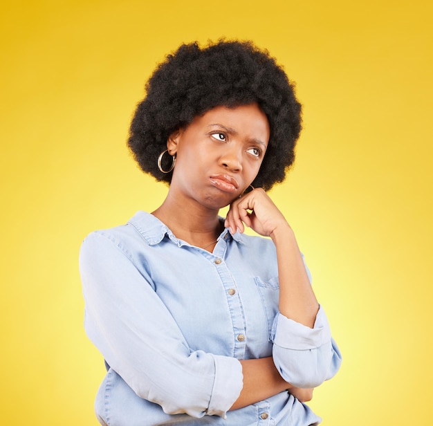 Photo black woman sad face and thinking in studio upset sulking and disappointed on a yellow background african female model think of memory problem or mental health with afro hair and color space