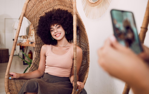 Photo black woman smile and swing chair with a phone for a photograph for social media blog or online marketing or advertising face of influencer happy while posing for profile picture as network user