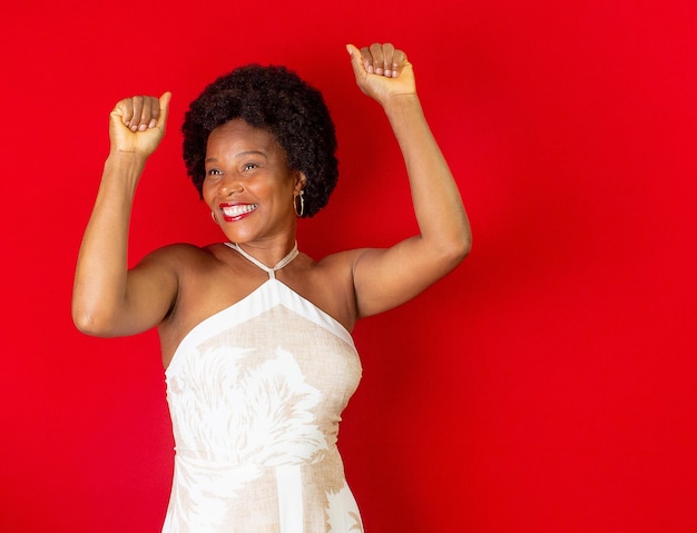 Black woman smiling and  doing a gesture of celebration