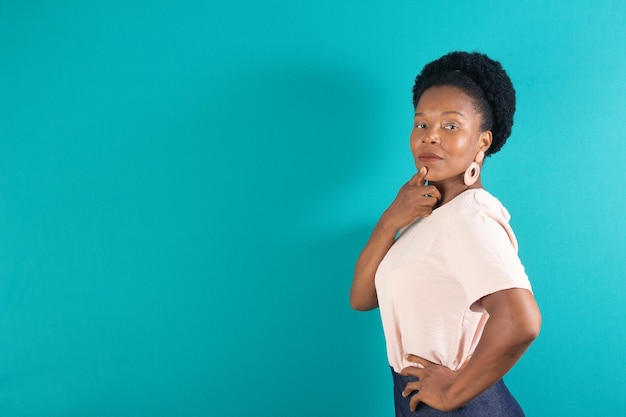 Black woman smiling and making a gesture with a green background