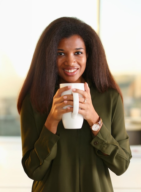 A black woman student in an office holds