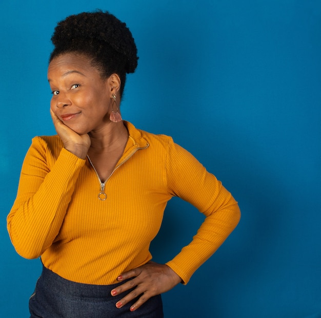 black woman thinking  with a blue wall