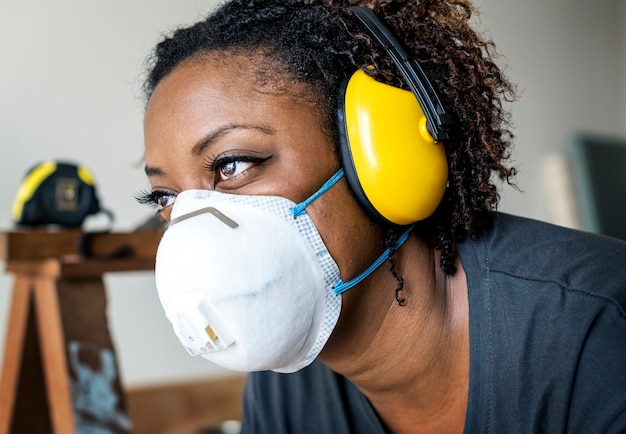 Black woman wearing ear protection