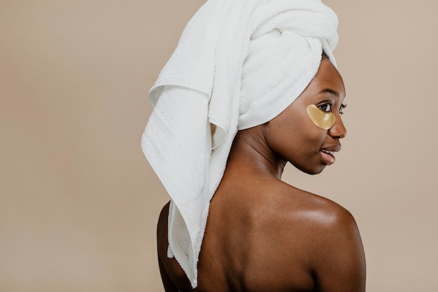 Black woman wearing a golden eye mask