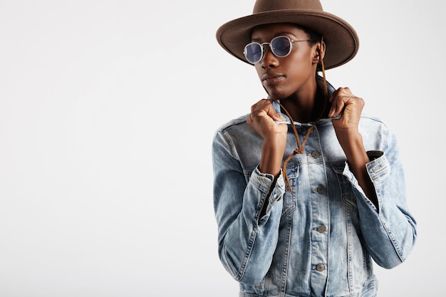 Black woman wears blue glasses and hat