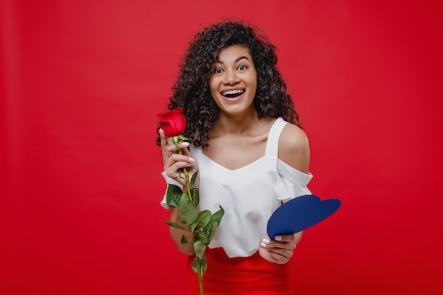 Black woman with blue valentine card and rose isolated