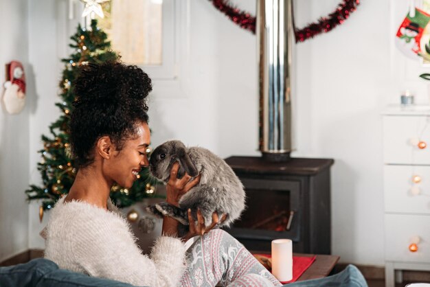 Black woman with rabbit on Christmas