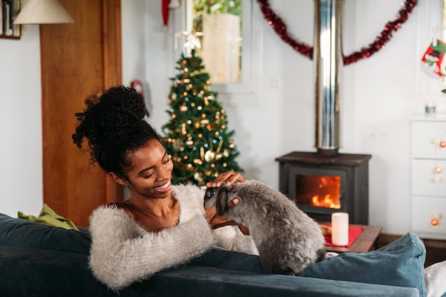 Black woman with rabbit on Christmas