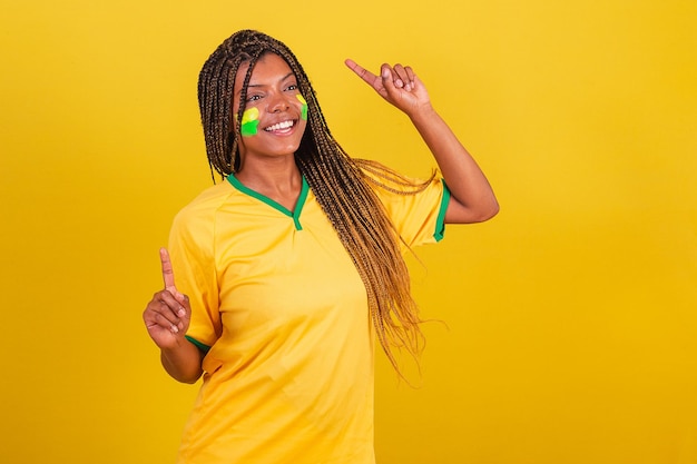 Black woman young brazilian soccer fan doing a celebratory dance