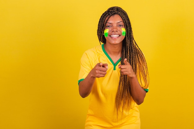 Black woman young brazilian soccer fan pointing at camera choosing you photo for advertising soccer brazil