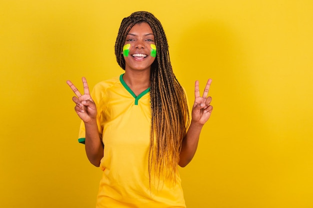 Black woman young brazilian soccer fan posing for selfie peace\
and love brazil soccer team