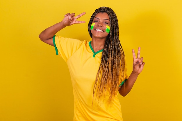 Black woman young brazilian soccer fan posing for selfie peace\
and love brazil soccer team