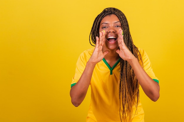 Black woman young brazilian soccer fan screaming promotion\
calling for promotion