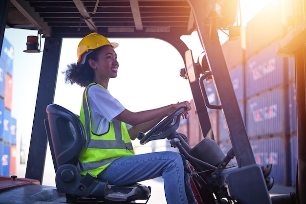 Black women american women afro of color work in an\
international shipping yard area export and import delivery service\
with containers