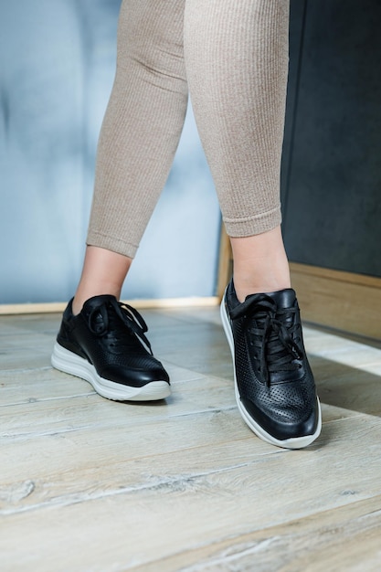 Black womens sneakers Collection of womens leather shoes Female legs in leather black casual sneakers Stylish womens sneakers