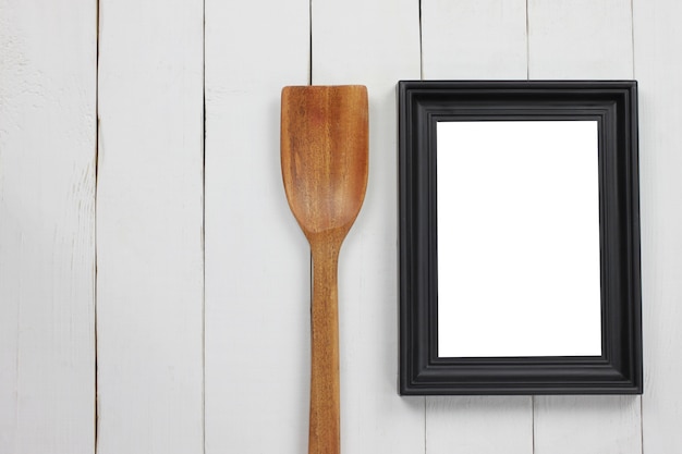 Black wood photo frame and wooden spatula.