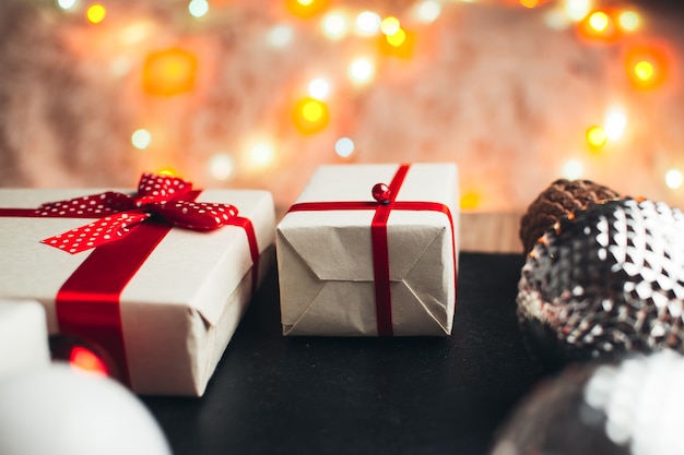 On a black wooden background lie the packaging of gifts