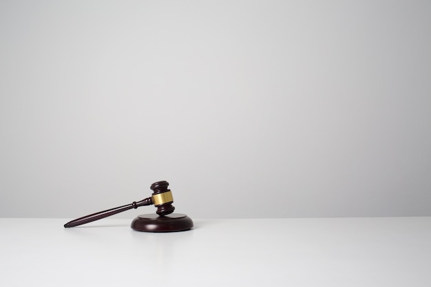 Black wooden gavel put on white desk table