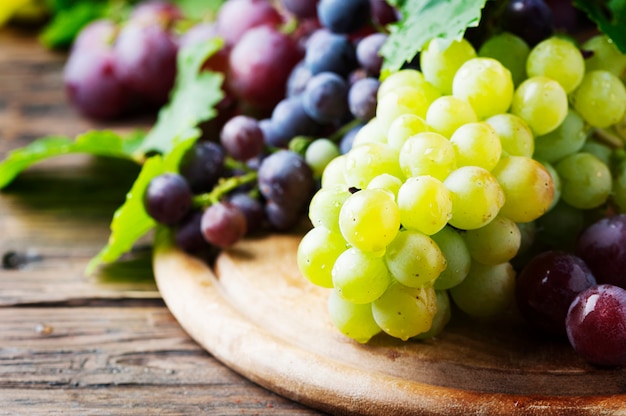 Black and yellow grape on the wooden table