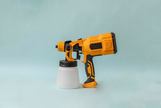 A black and yellow sprayer gun tool isolated