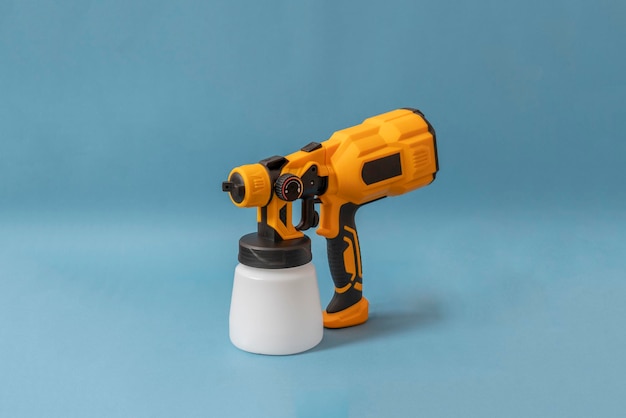 A black and yellow sprayer gun tool isolated