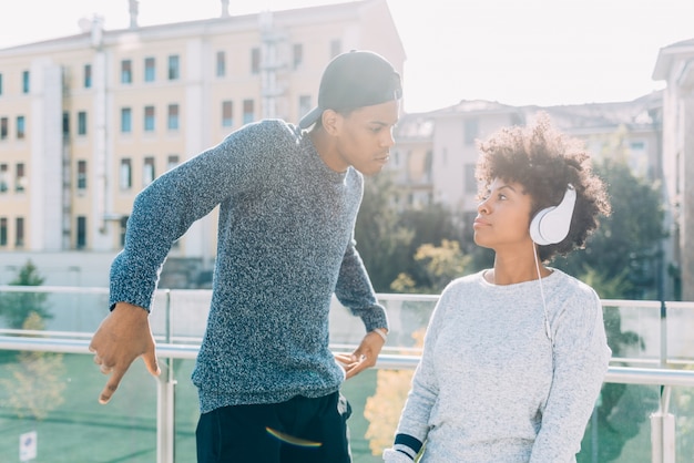 Black young couple having fun and listening to music