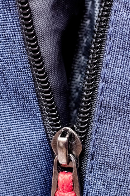 Black zipper on a blue bag closeup