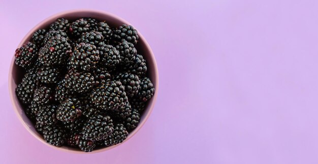 Blackberries in a bowl flat lay.Copy space.