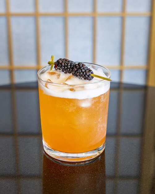 Blackberries Garnishing a sweet yet tangy rum sour cocktail