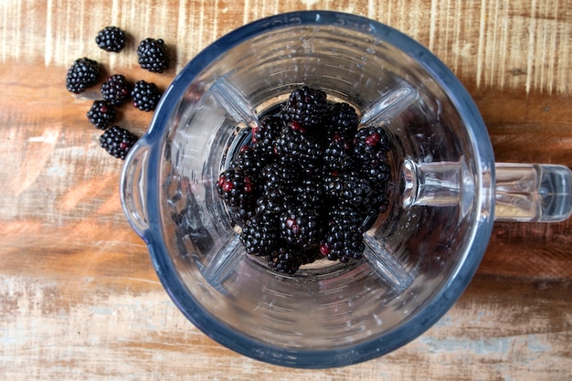 blackberry into the blender top view. Red fruit.