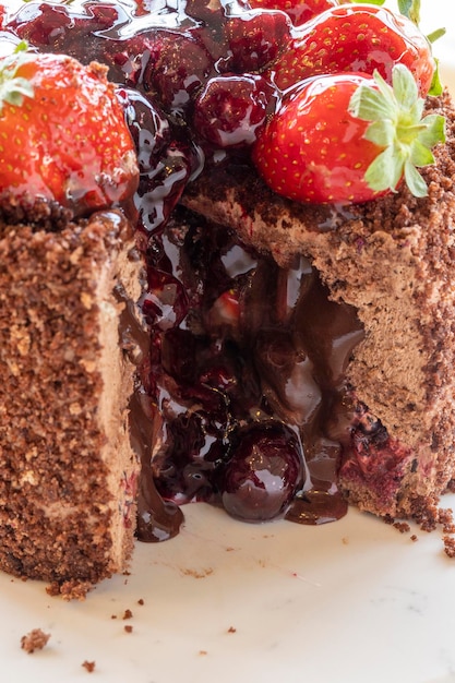 Blackberry strawberry and flowing chocolate cake close up