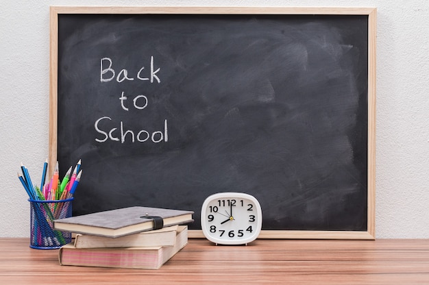 blackboard back to school with pencils and books