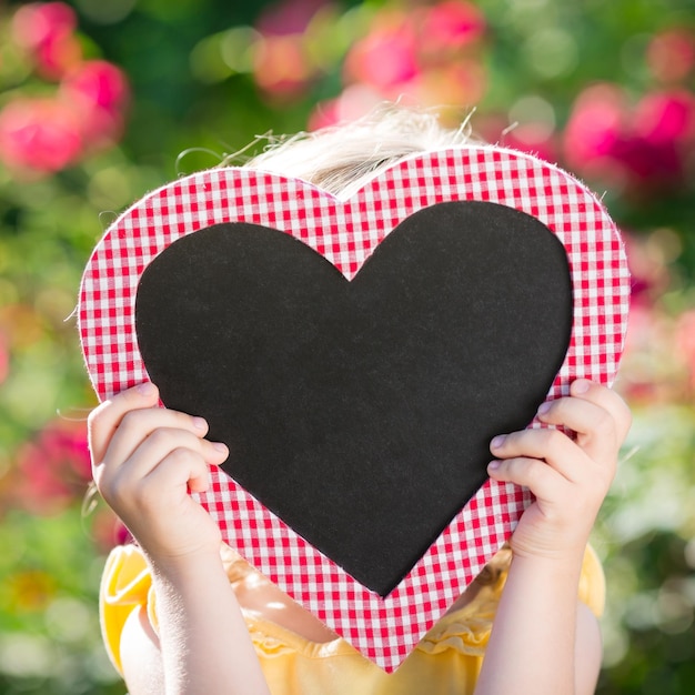 Blackboard blank in hands outdoors