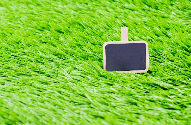 blackboard message clip on green grass