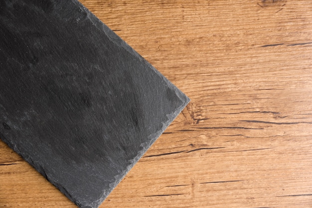 Blackboard plate on wooden background