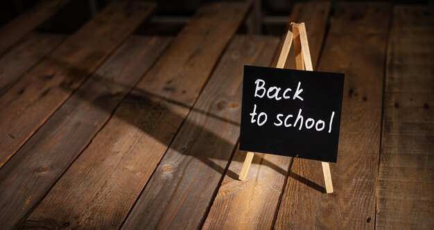 Photo blackboard with back to school text dark wooden background copy space