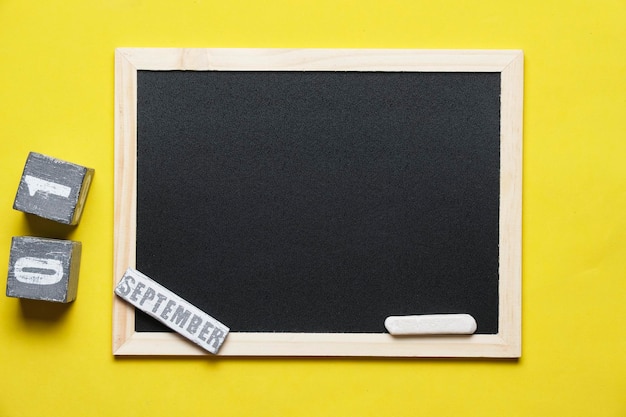 Photo blackboard with chalk yellow background and september 01 on calendar