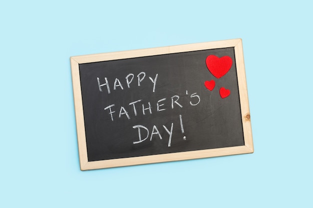 Blackboard with fathers day greeting on a light blue background