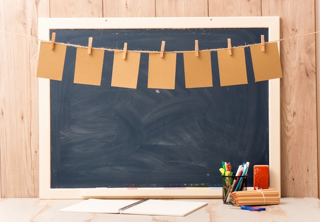 Blackboard with seven small sheets of paper