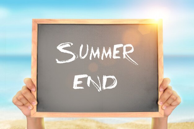Photo blackboard with summer end text on the beach