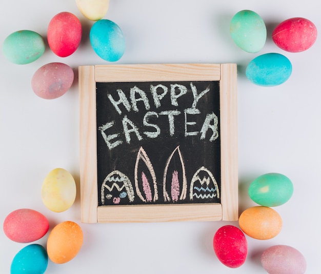 Blackboard with the text to Easter around eggs. 